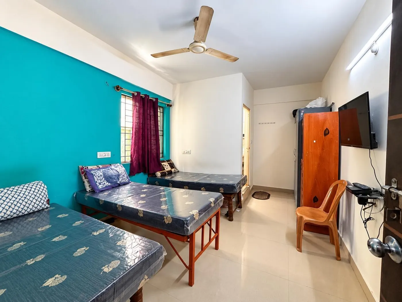 Triple-sharing room with three beds
